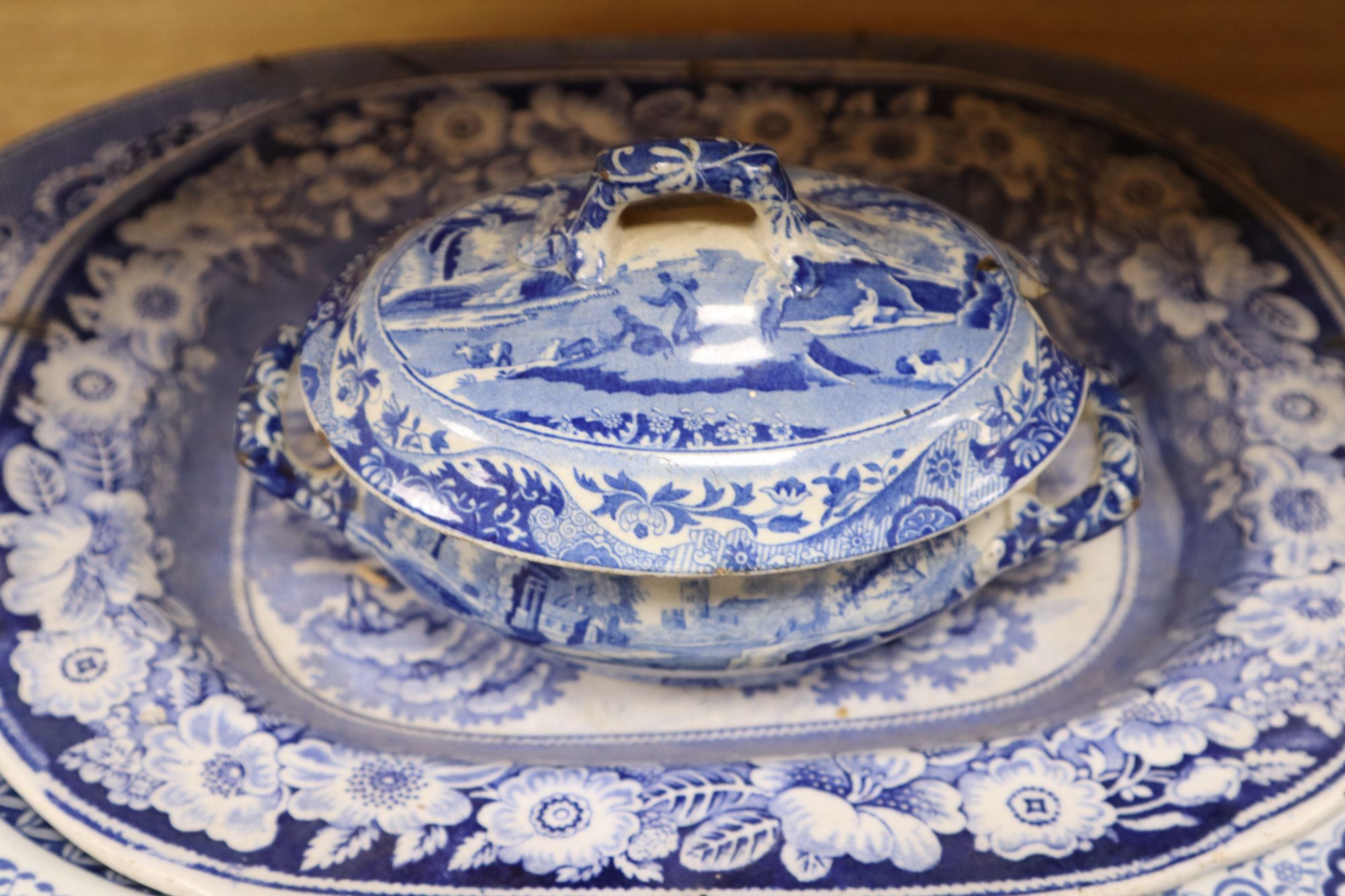 Three blue and white meat platters, largest 49cm wide, two ironstone plates and a tureen and a Delft vase